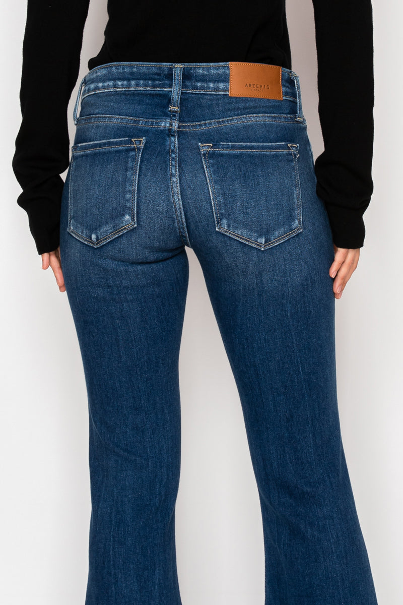 Artemis Vintage Margaret low-rise vintage flare jeans in dark-wash stretch denim with knee distressing.
